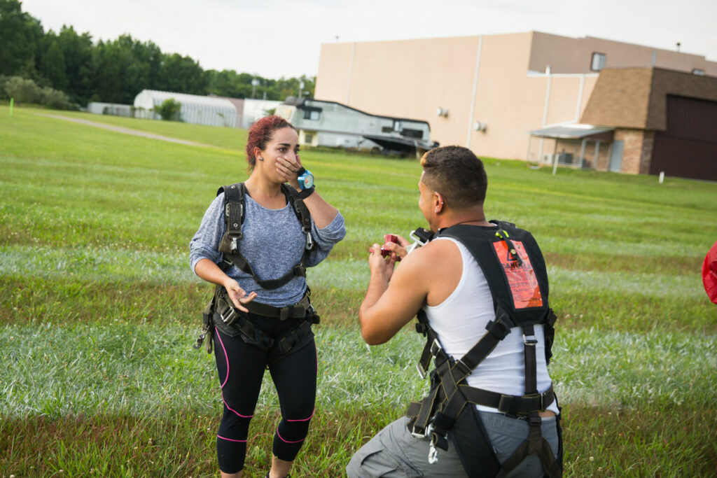 Skydiver wedding proposal after landing.