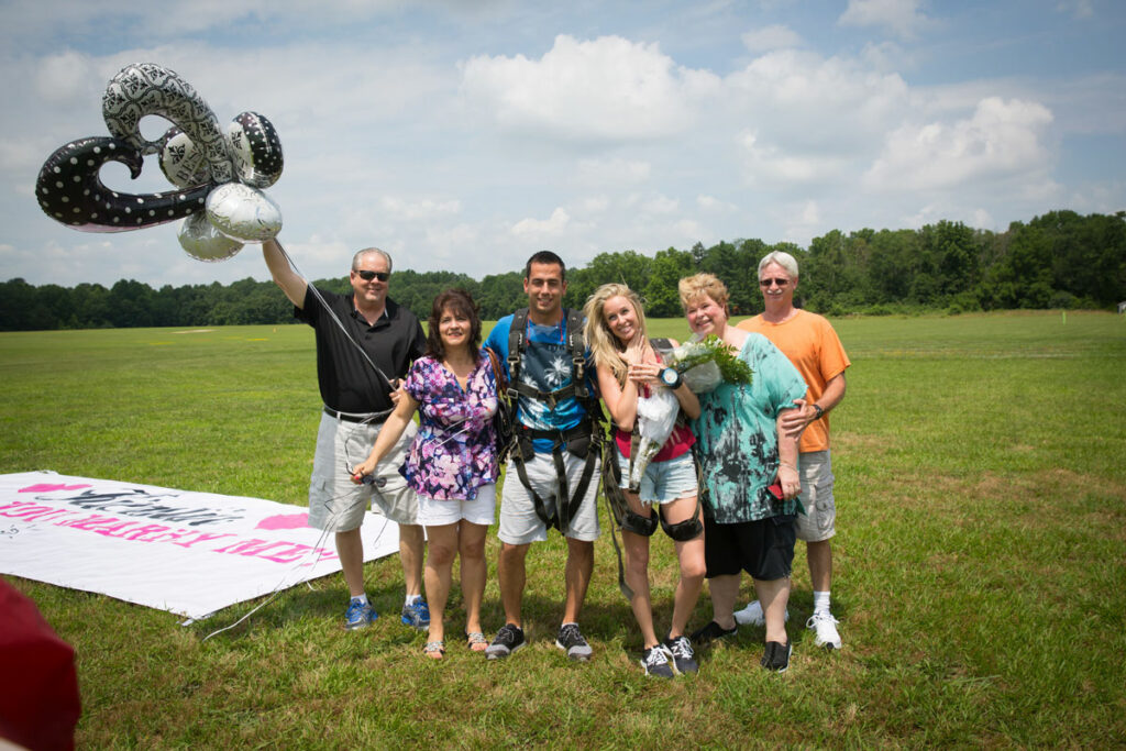 Skydiving wedding proposal party with balloons.